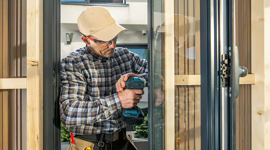 Handyman working on outdoor sliding door installation